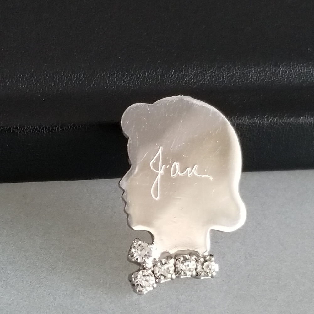 Silver Tone woman's head brooch engraved "Jan"